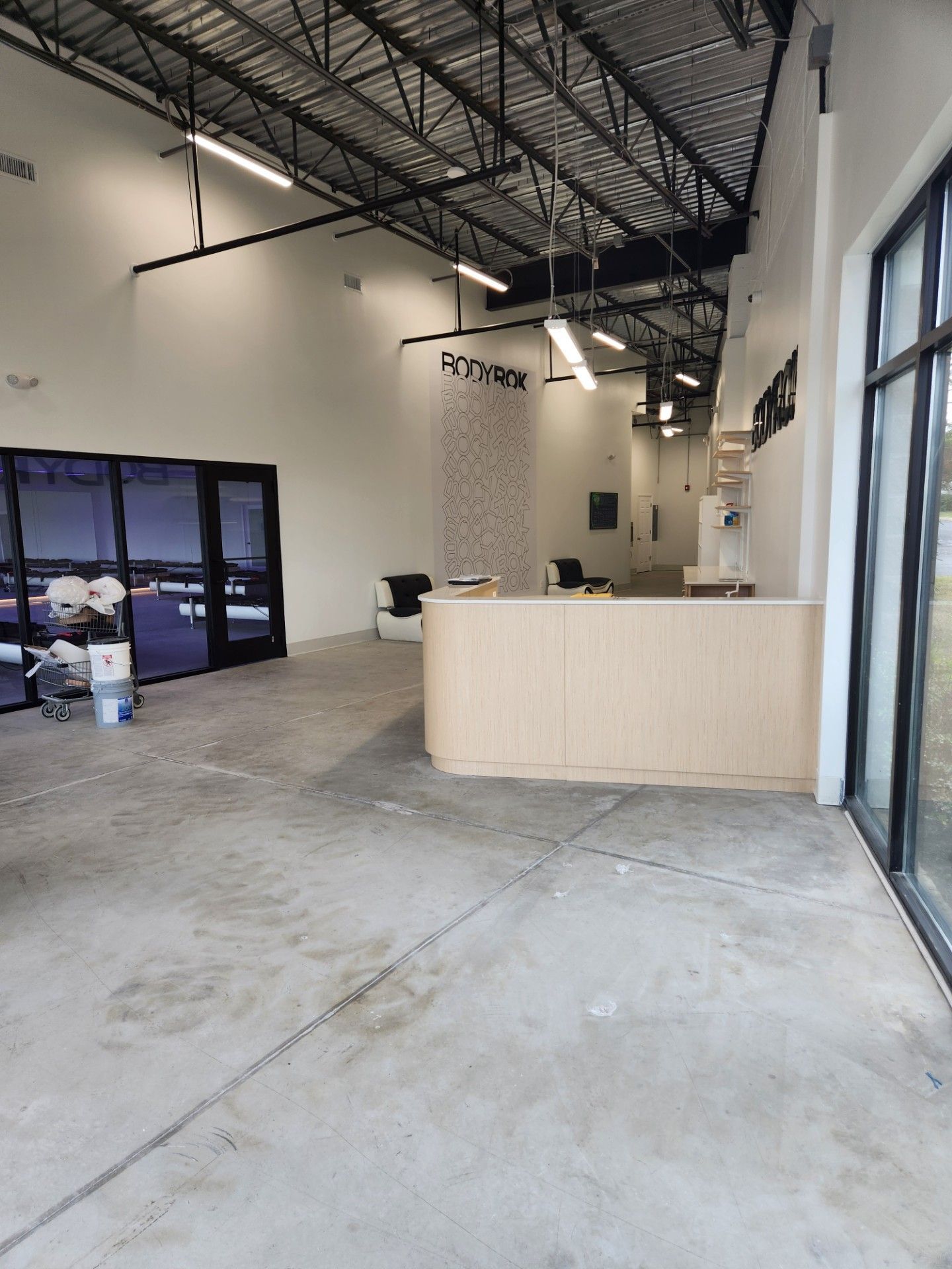 A large empty room with a counter in the middle of it.