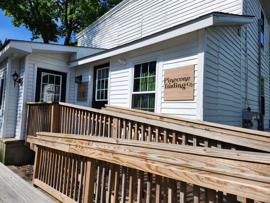 A white house with a wooden ramp leading to it.