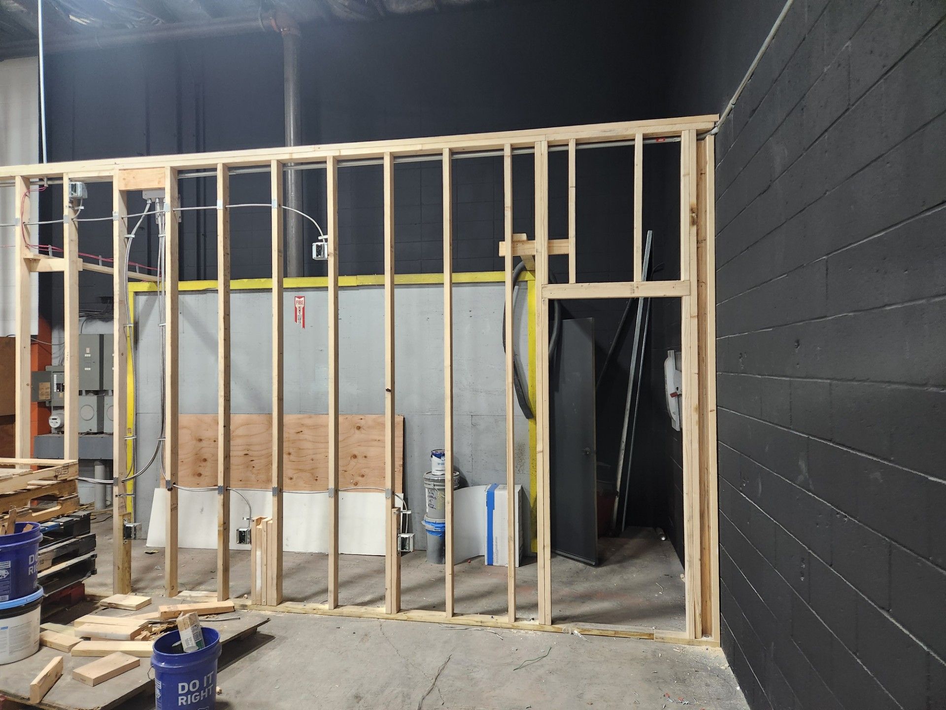 A room with a black wall and a wooden frame