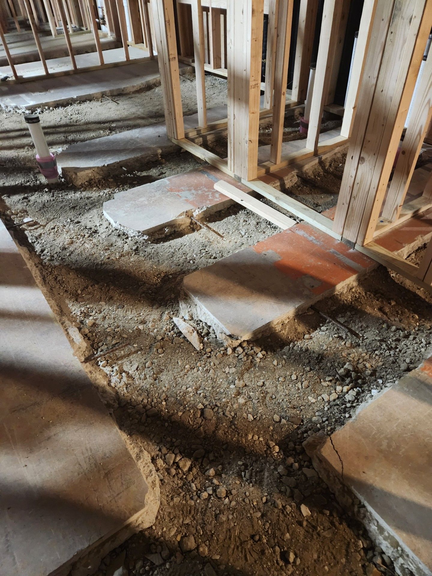 A building under construction with a lot of dirt on the floor.