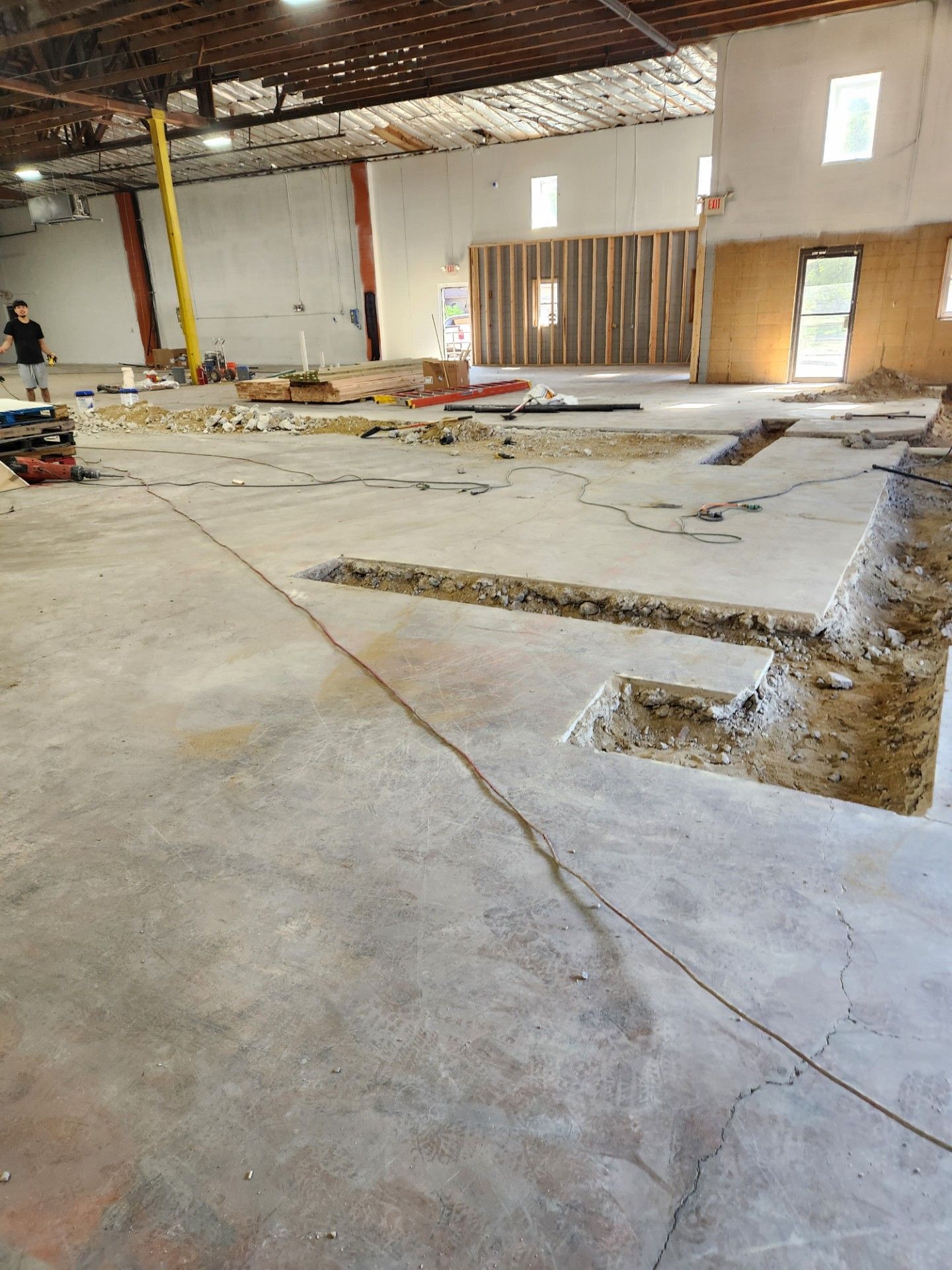 A large building under construction with a hole in the floor.