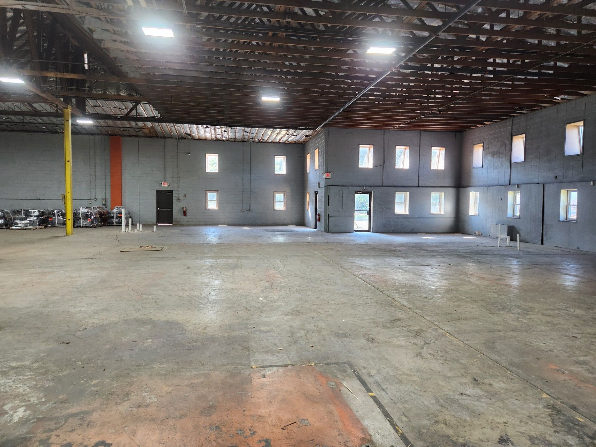A large empty warehouse with a lot of windows