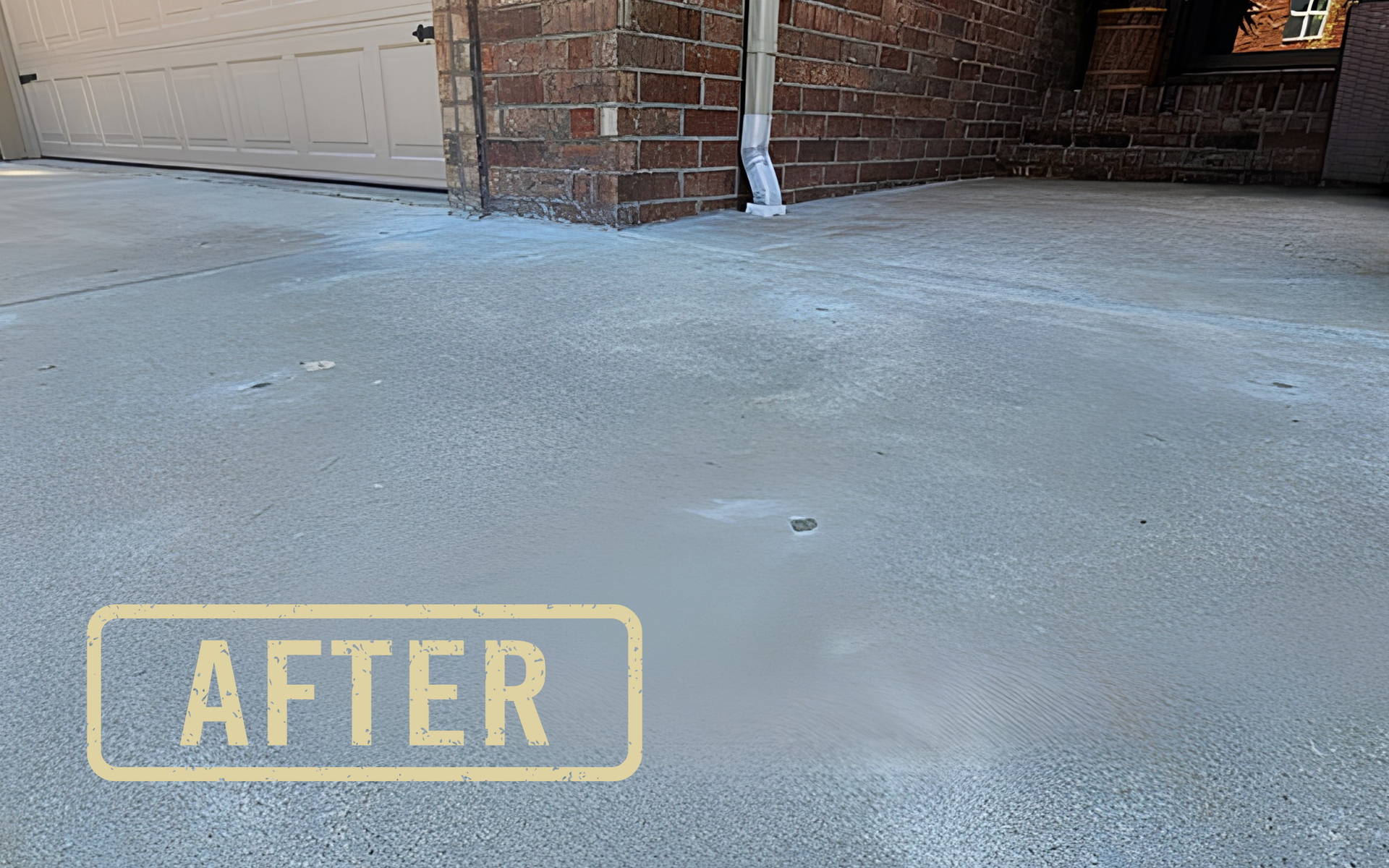 Concrete driveway beside a brick wall and garage