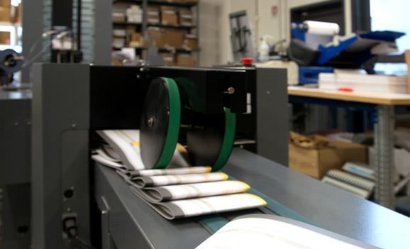 A conveyor belt with a bunch of papers on it