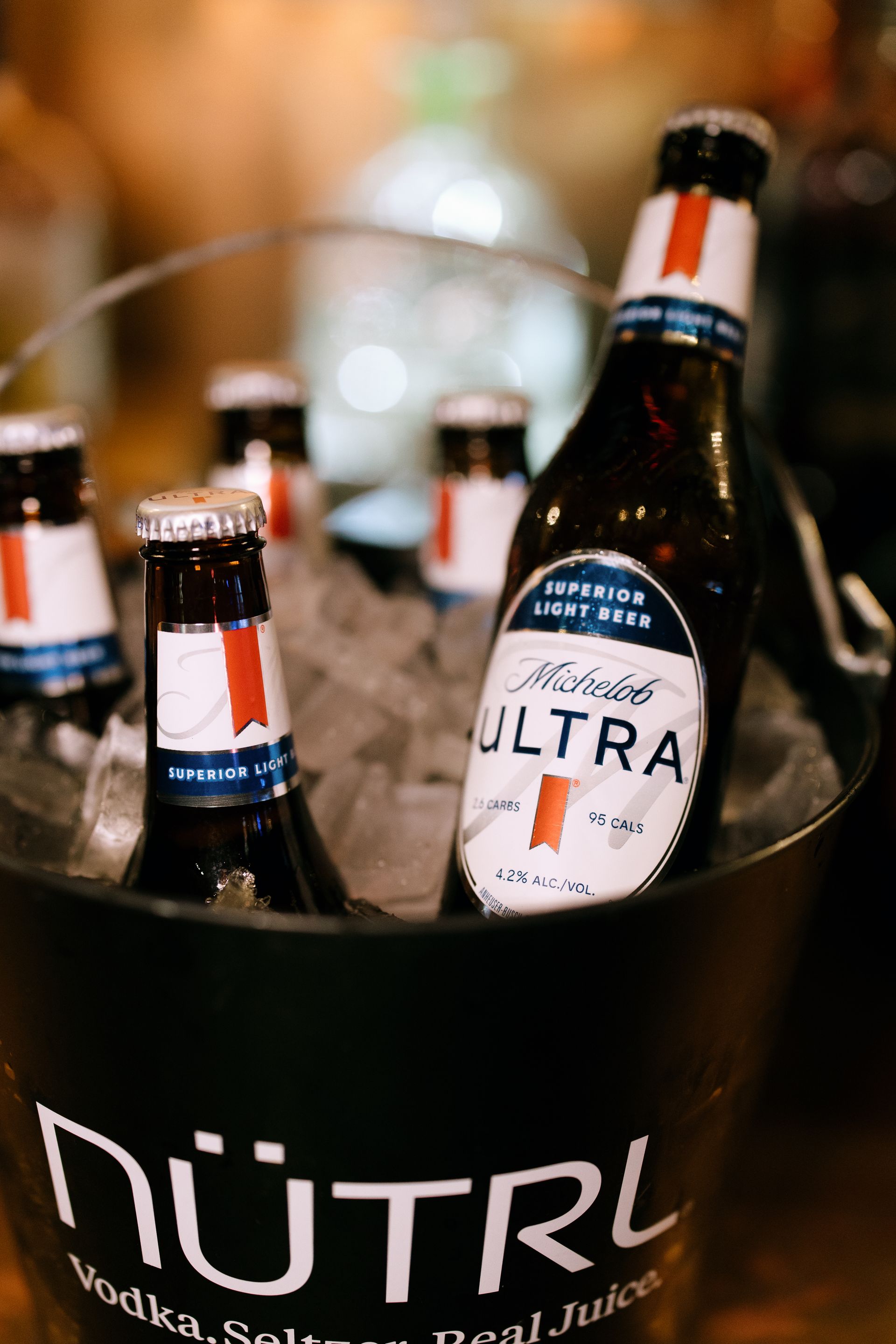Bucket of ice with Miller Lite bottles; a 