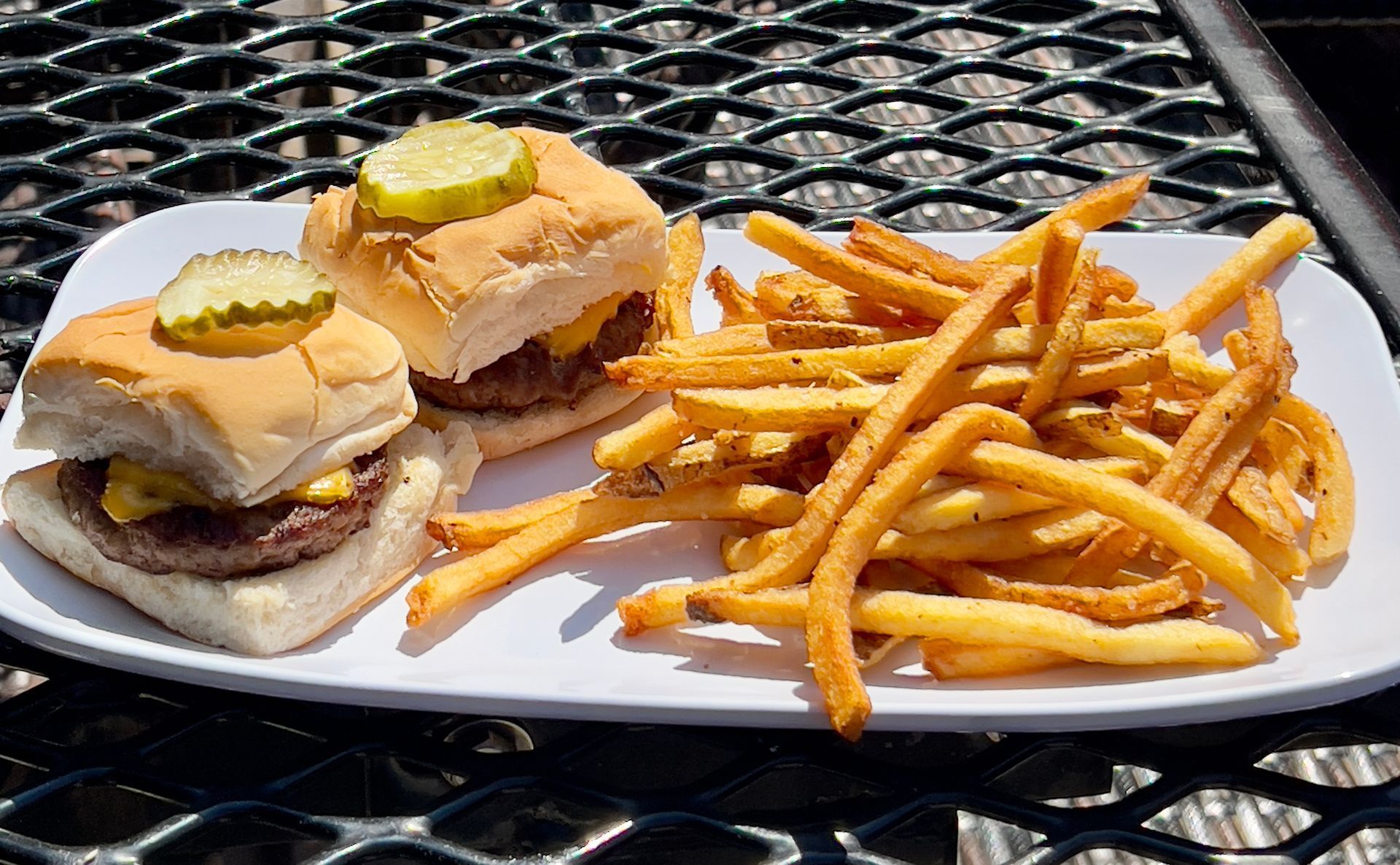 Chicken slider with cheese on a bun.