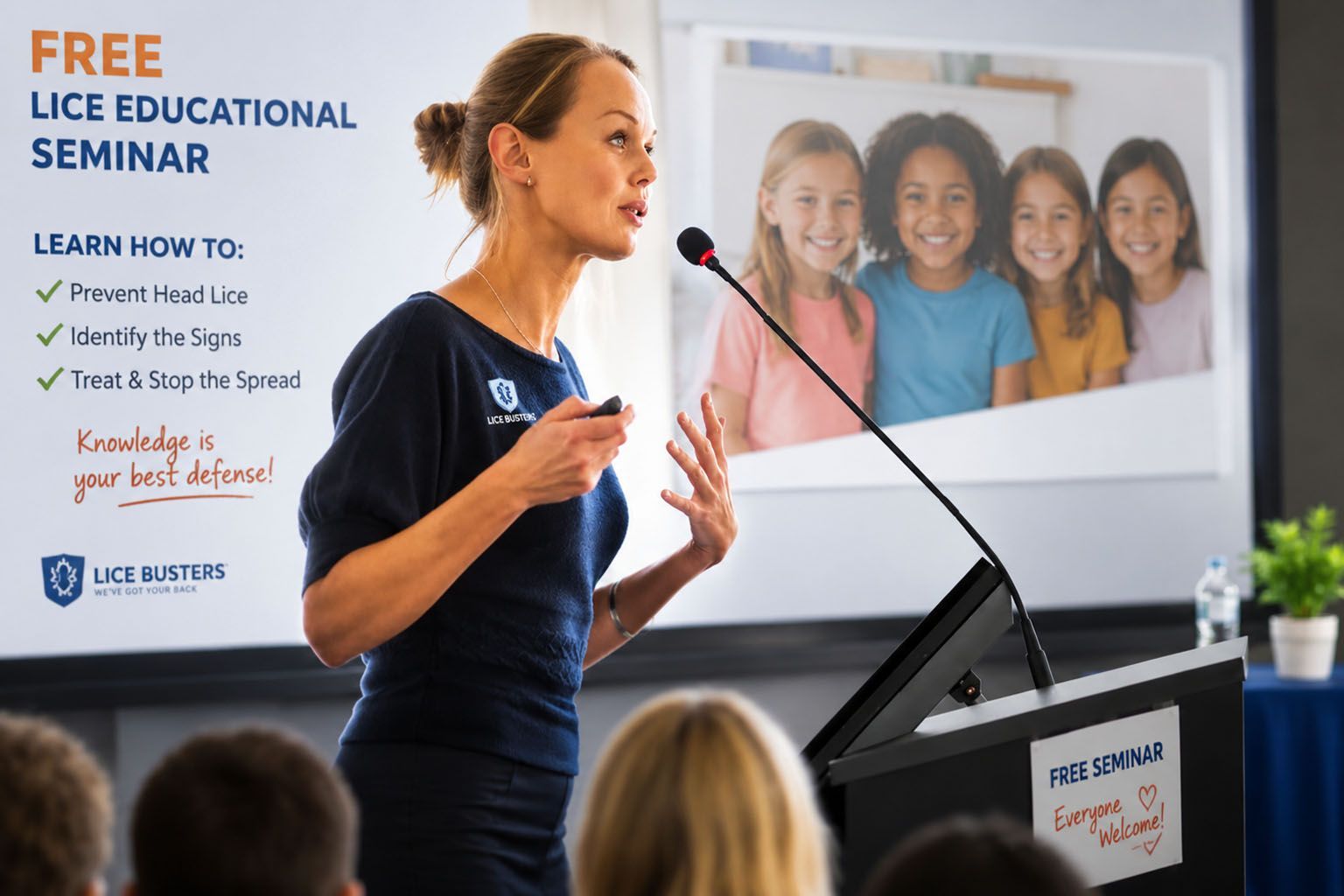 A woman is giving a speech at a podium in front of a microphone.