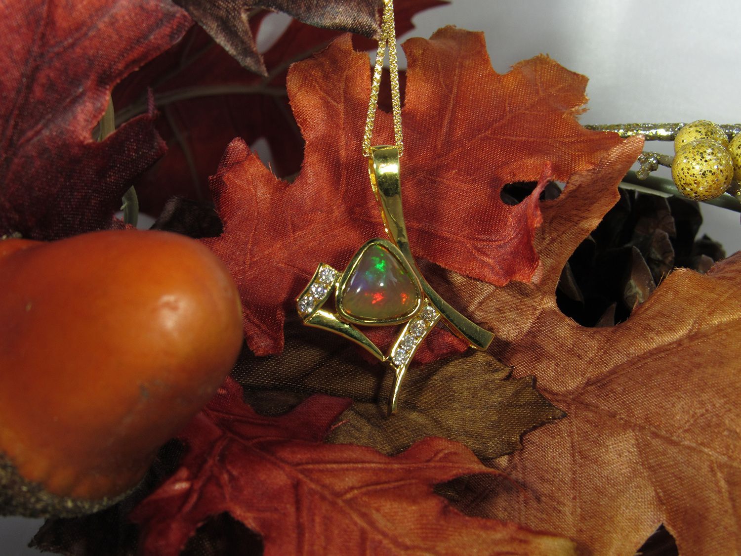 A necklace is sitting on top of a pile of leaves