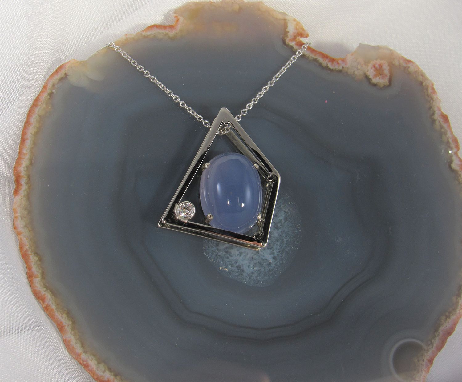 A necklace is sitting on a piece of agate
