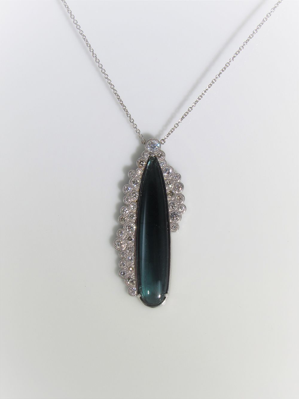 A necklace with a pendant that looks like a surfboard