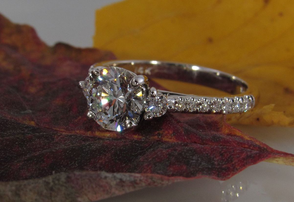 A diamond ring is sitting on top of a leaf