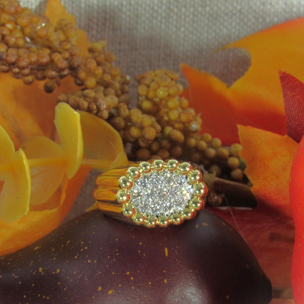 A close up of a ring surrounded by flowers and leaves