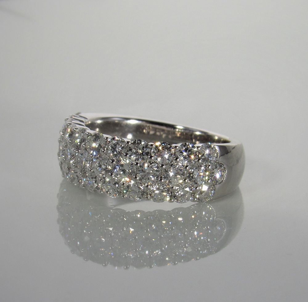 A white gold ring with a lot of diamonds on it