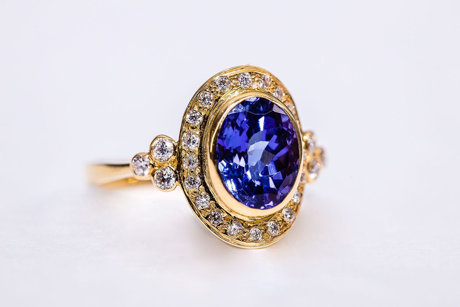 A yellow gold ring with a sapphire and diamonds