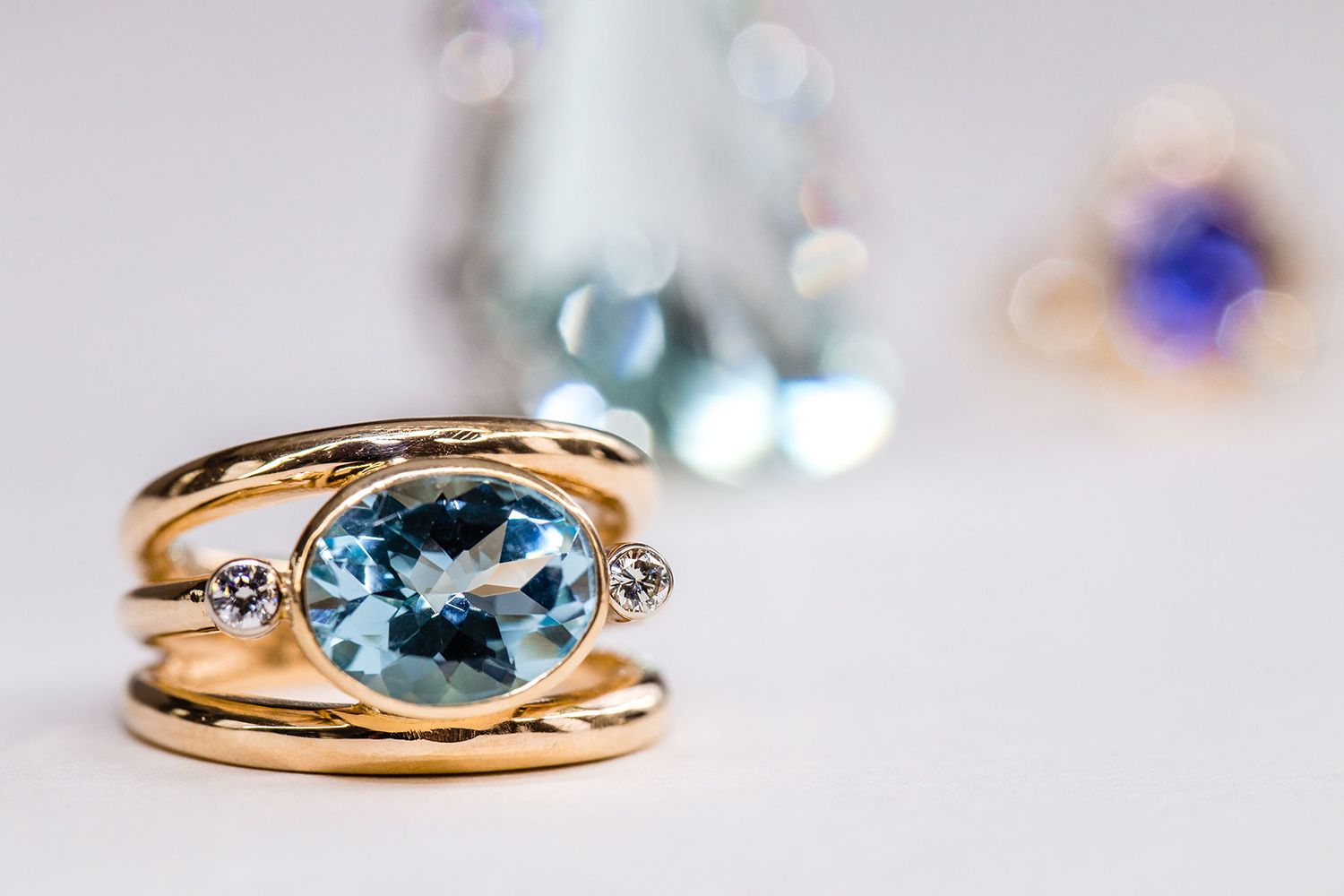 A close up of a ring with a blue stone on a table
