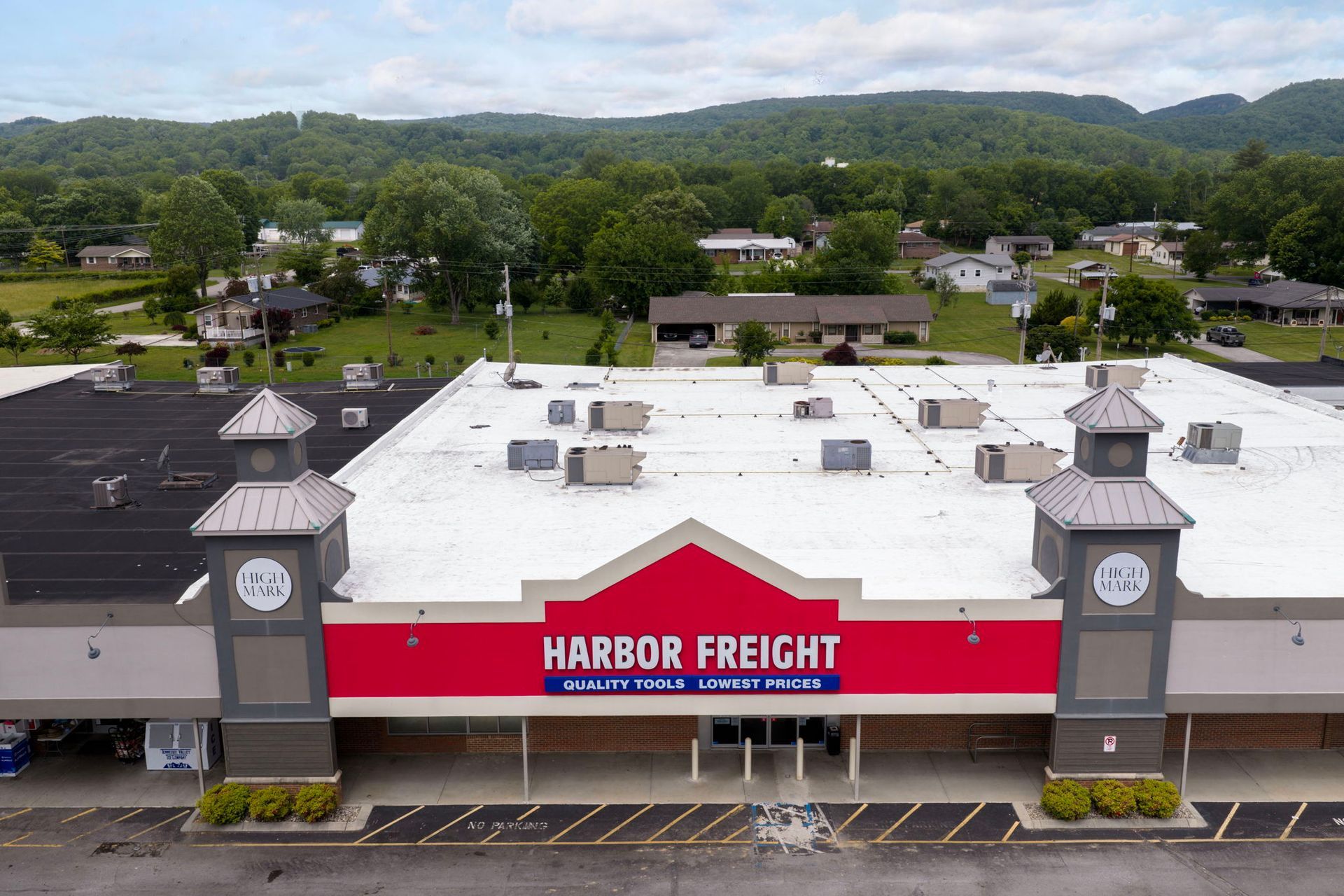 Harbor Freight storefront with red sign and twin clock towers in a shopping center parking lot