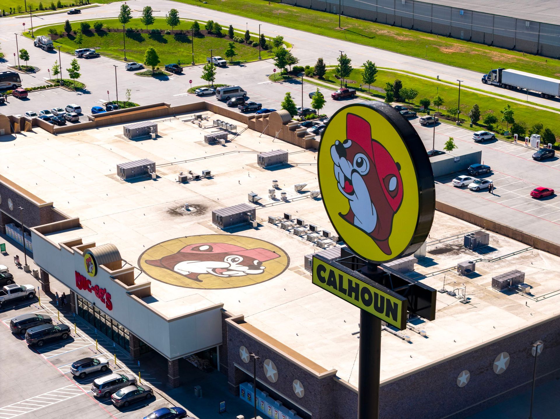 Aerial view of a Buc-ee’s store with a large beaver sign and parking lot.