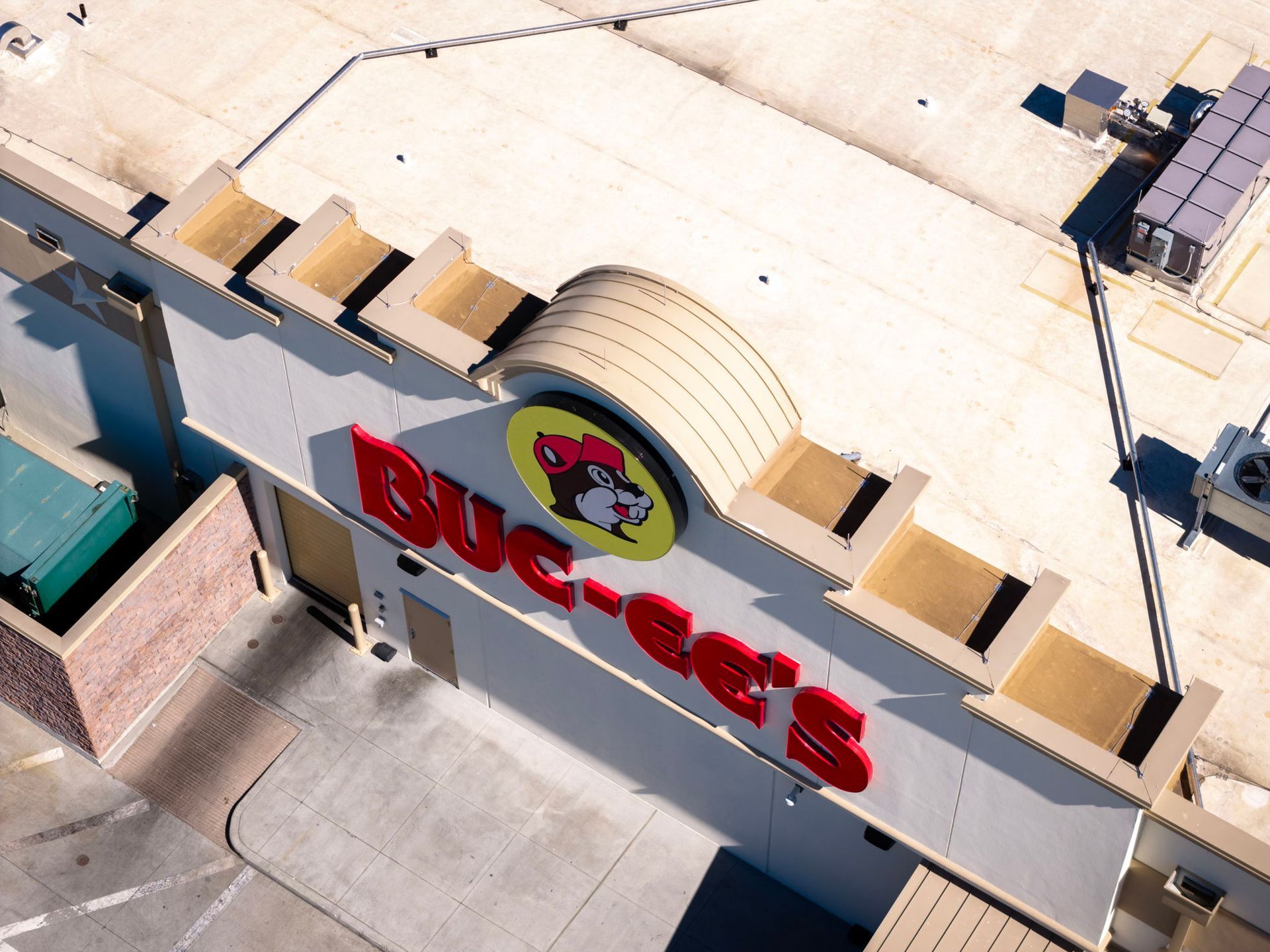 Aerial view of a Buc-ee’s store with red sign and beaver logo on the roof.