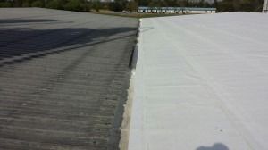 A split-view image showing a weathered, grey corrugated metal roof on the left and a new, smooth white roof on the right.