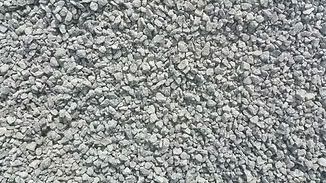 Gray gravel stones covering the ground, creating a rough textured surface