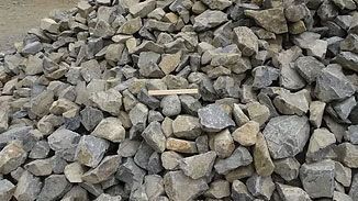 Pile of gray rocks and gravel stones spread across the ground