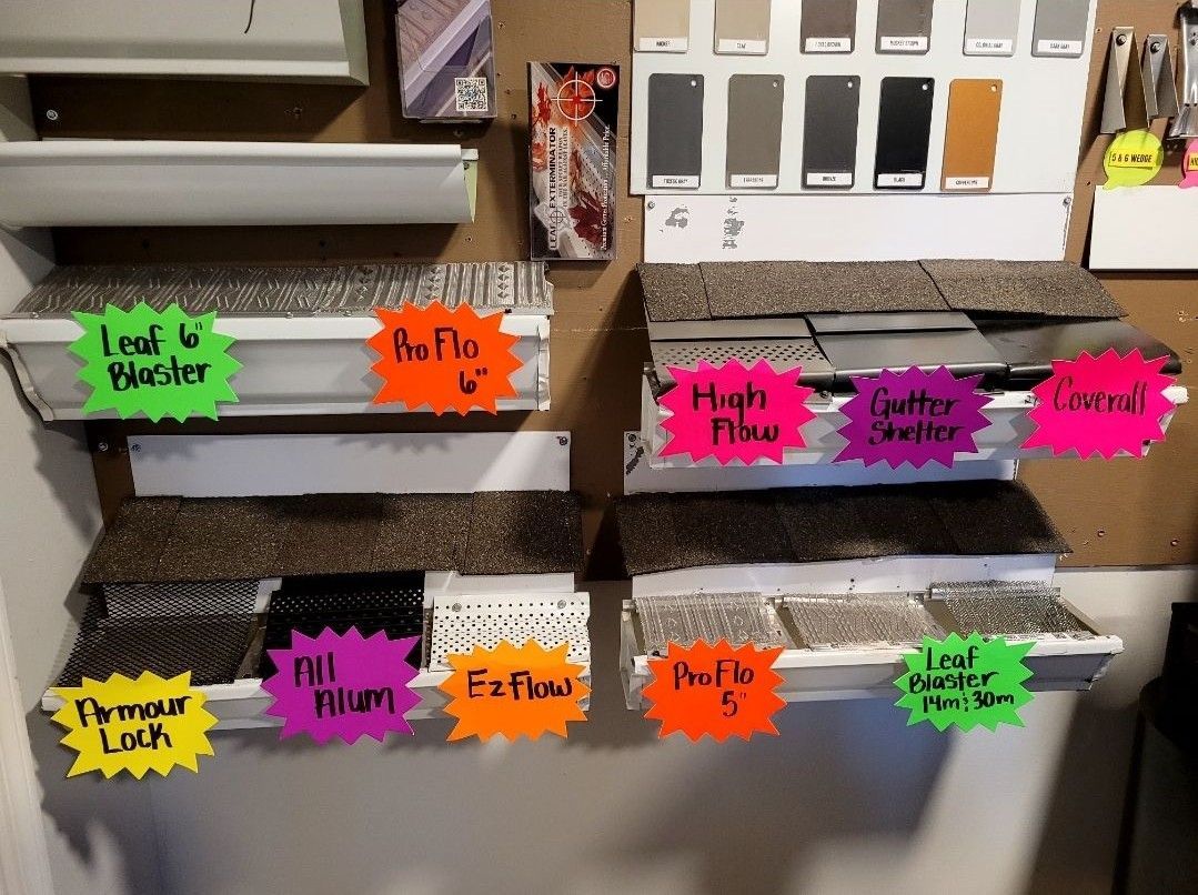 Display of roofing and gutter samples with color swatches and labeled options.