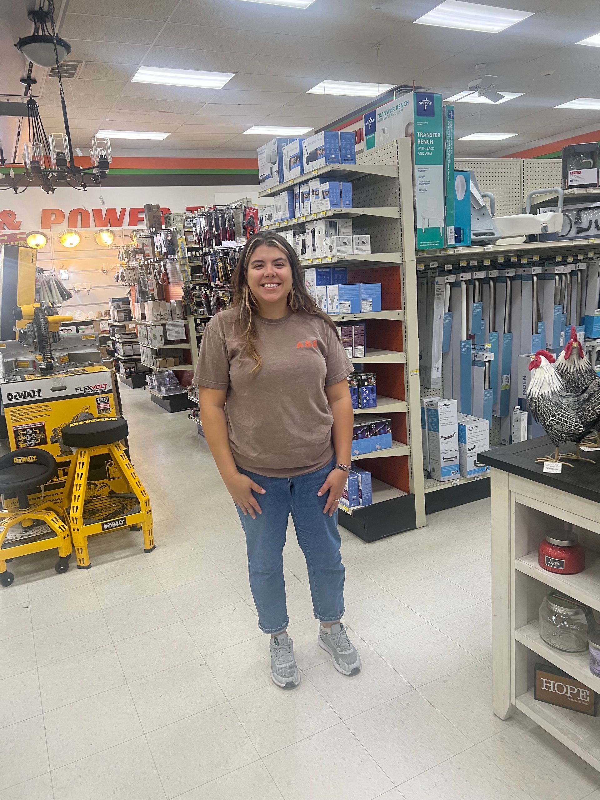 A woman is standing in a hardware store.