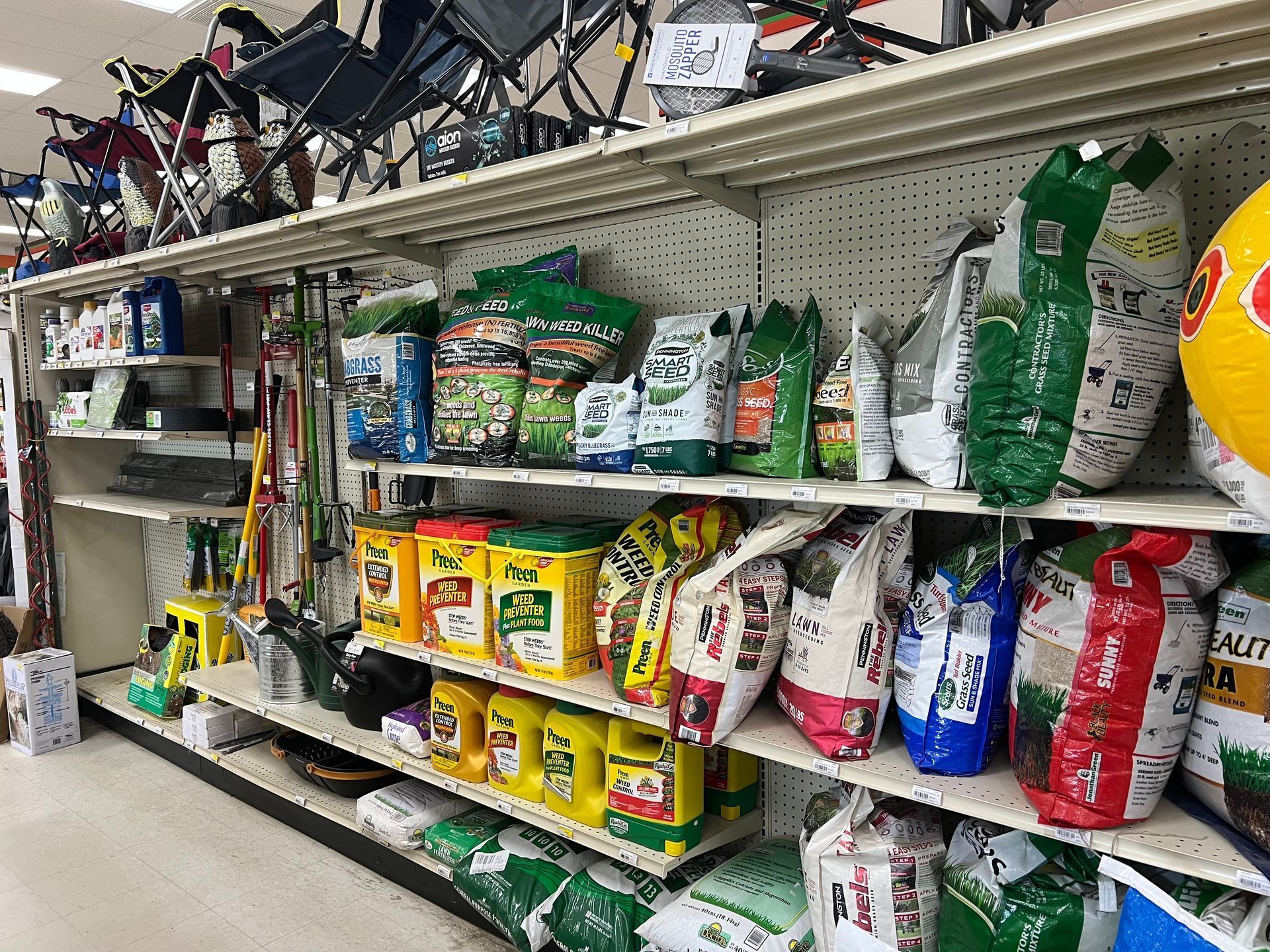 A shelf in a store filled with bags of lawn fertilizer.