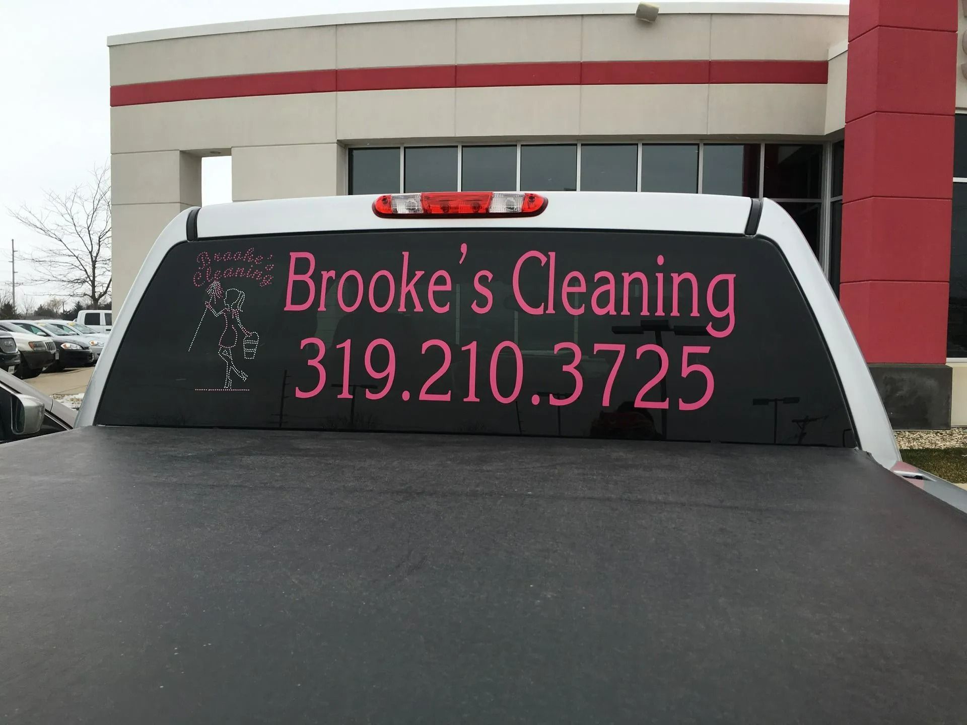 Van with “Brooke’s Cleaning” and phone number 319.210.3725 on rear window