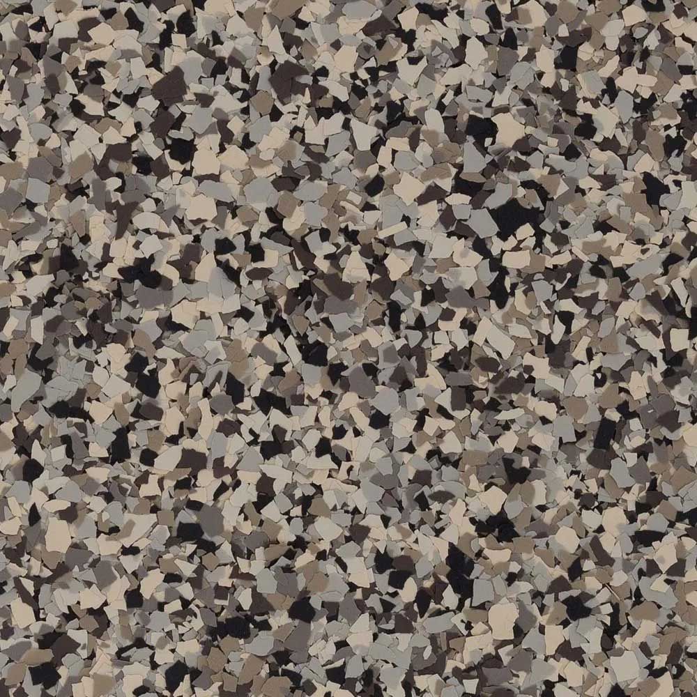 Speckled epoxy floor coating, with black, brown, and tan chips.