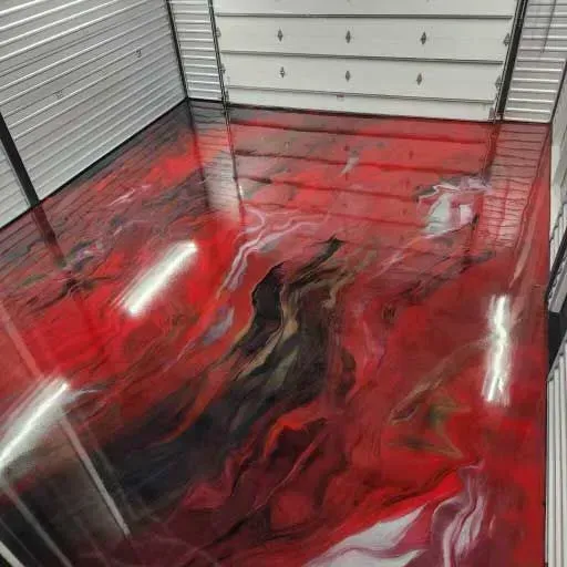 Red and black epoxy floor in a garage with a metallic finish.