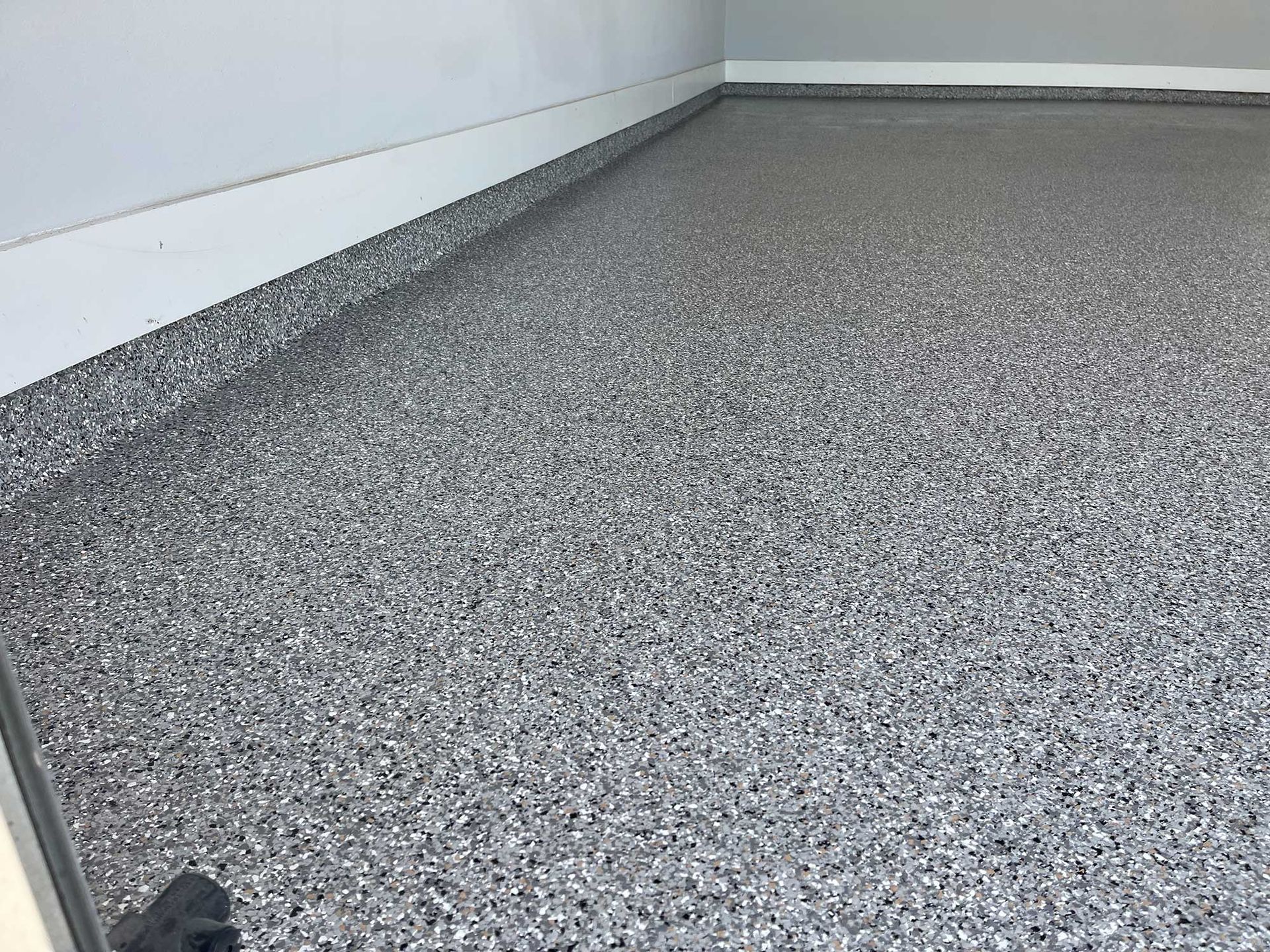 Gray speckled epoxy garage floor.