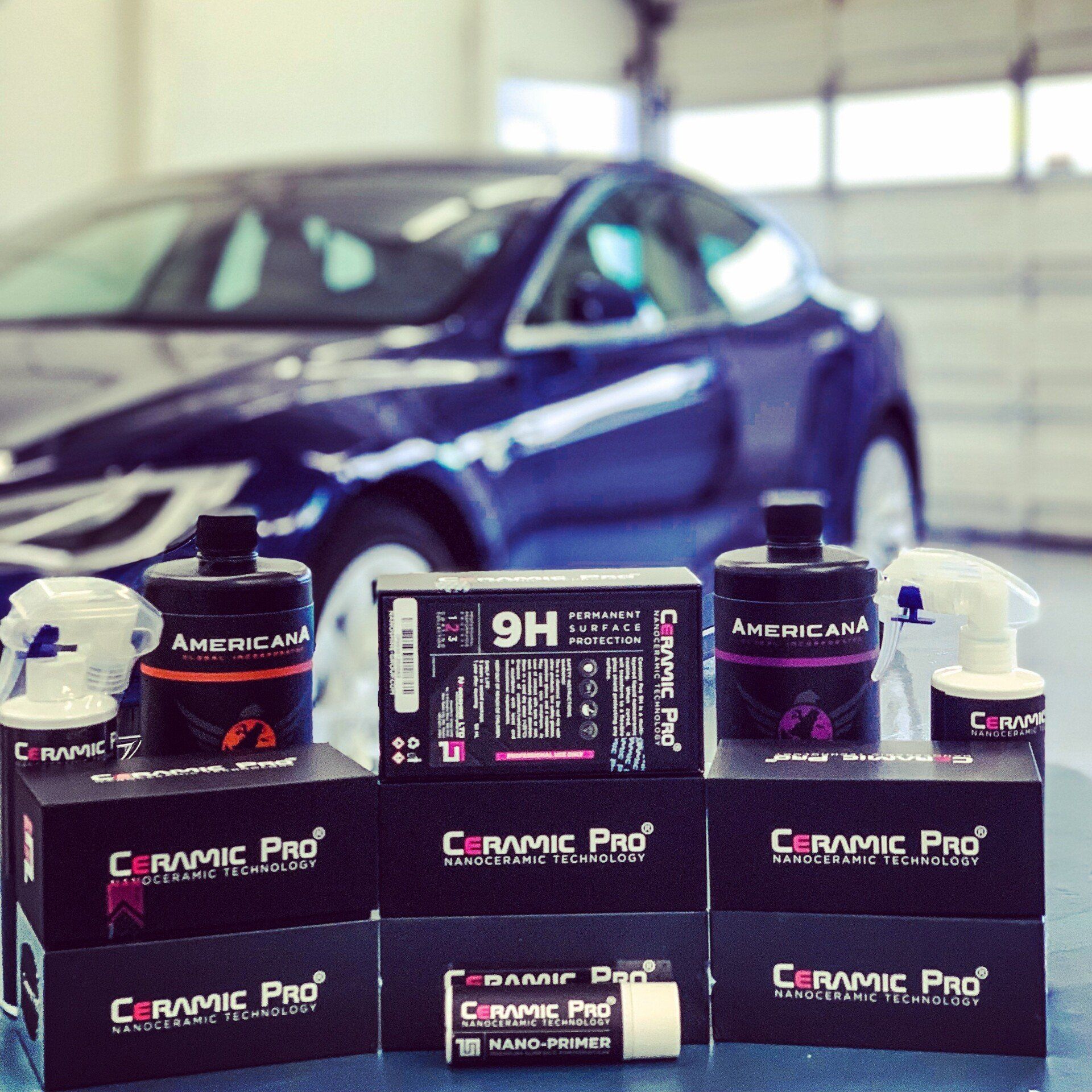 Ceramic Pro Products and a Blue Car in the background