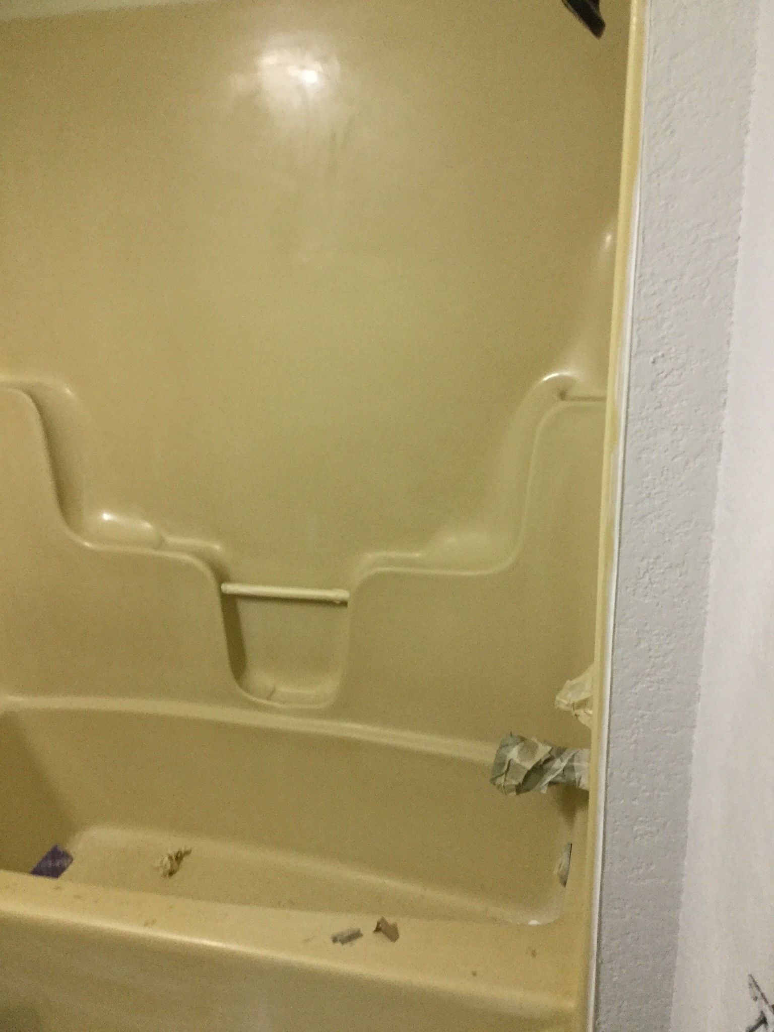 a bathtub with a shower stall attached to it in a bathroom