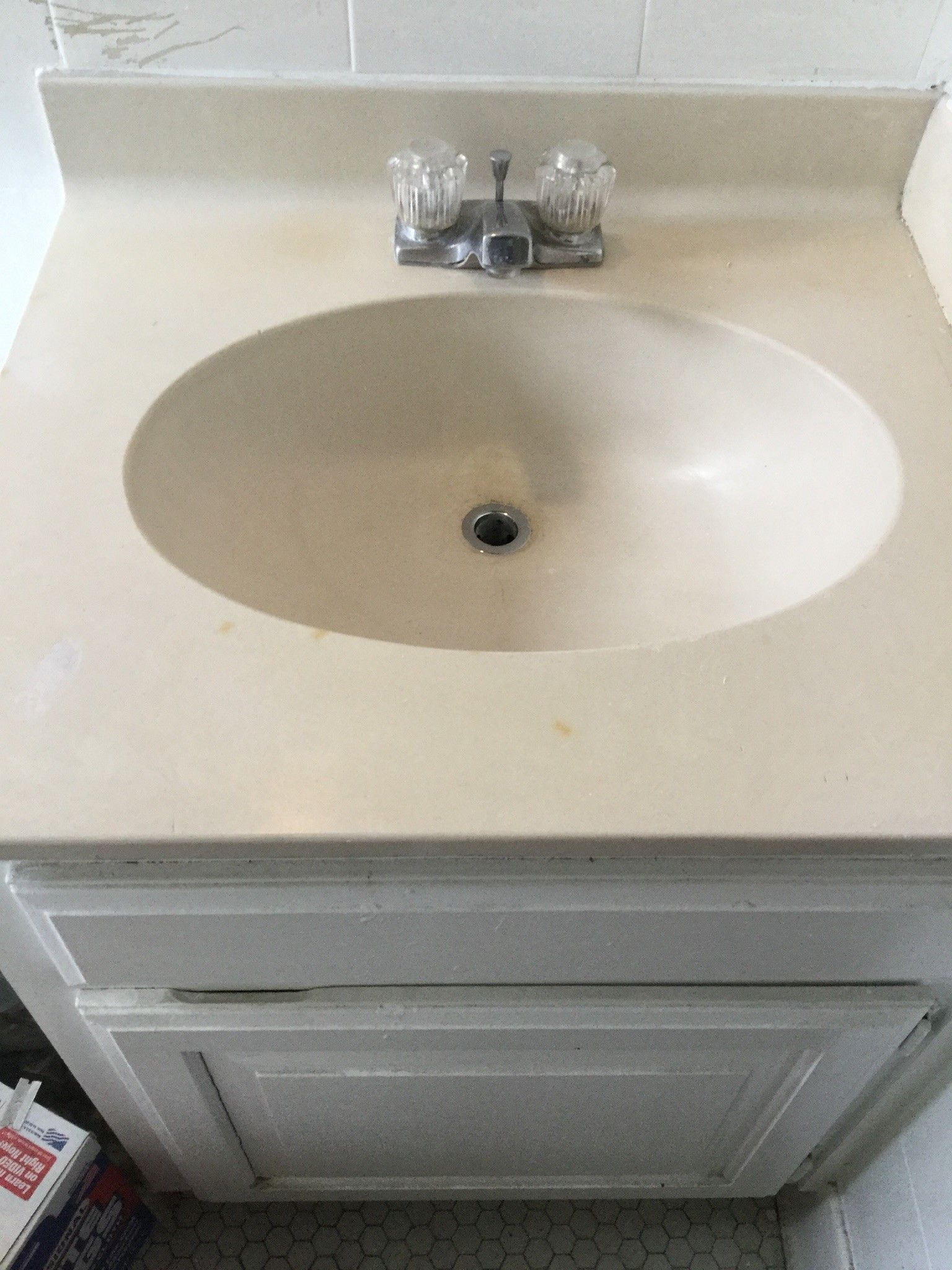 a bathroom sink with a white cabinet underneath it