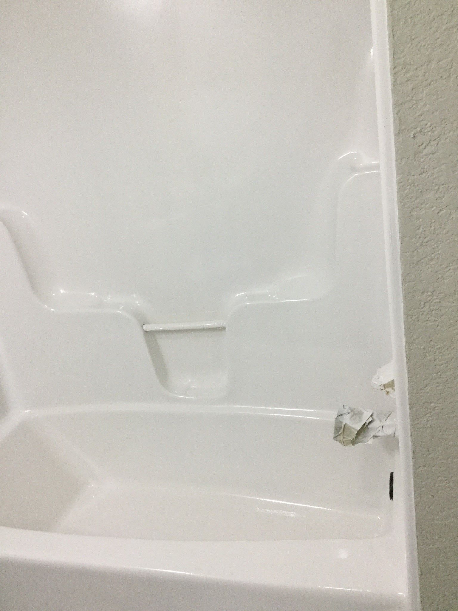 a white bathtub with a shower stall attached to it