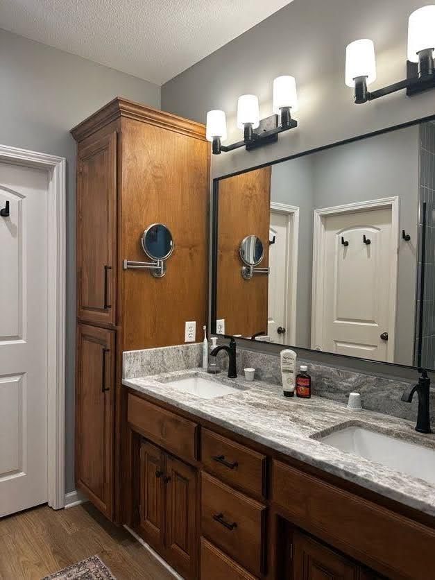 A bathroom with two sinks and a large mirror.