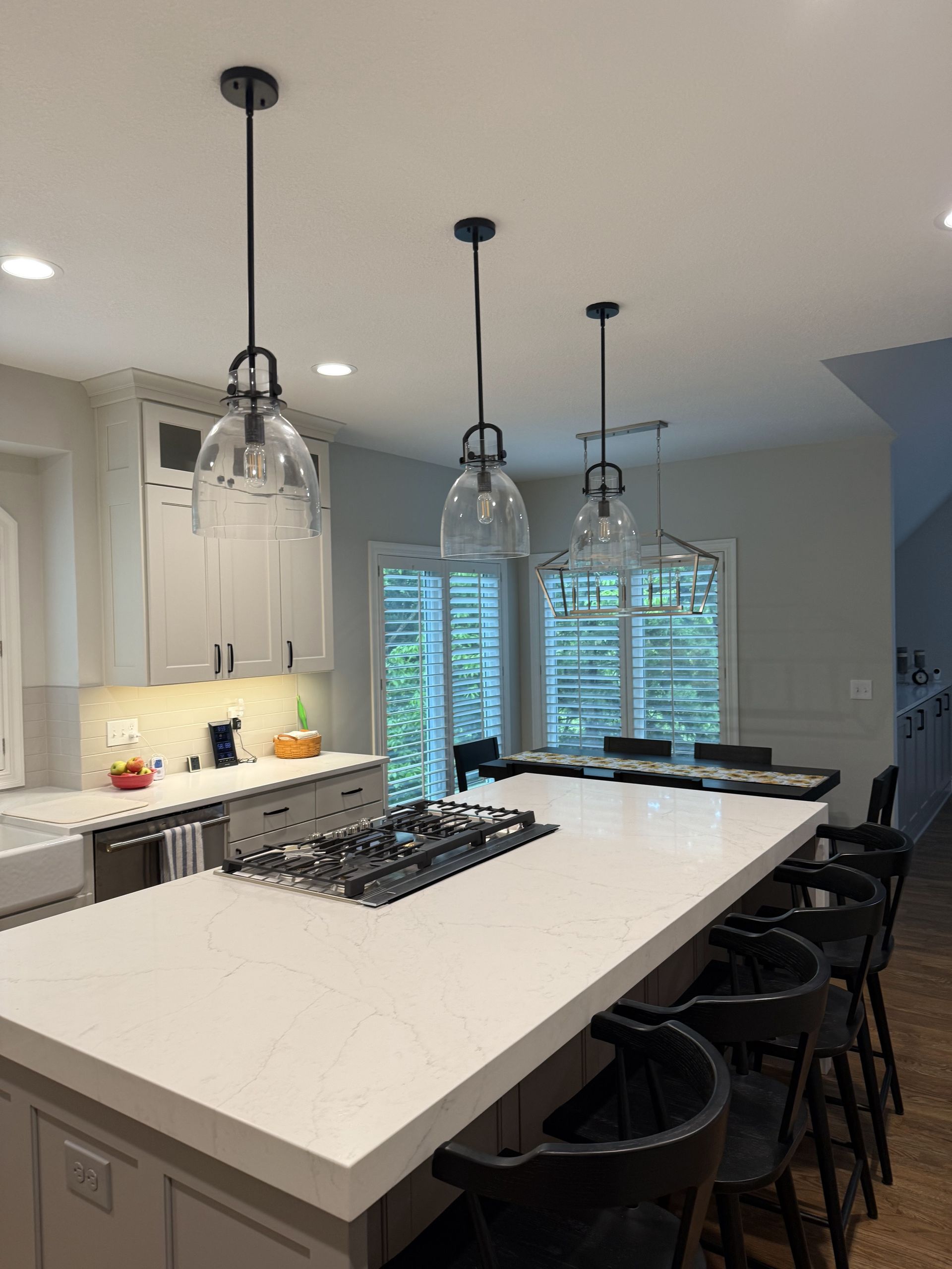 A kitchen with a large island and a stove top oven