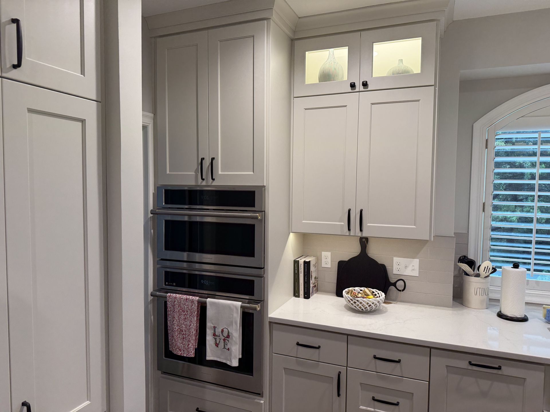 A kitchen with white cabinets and stainless steel appliances.