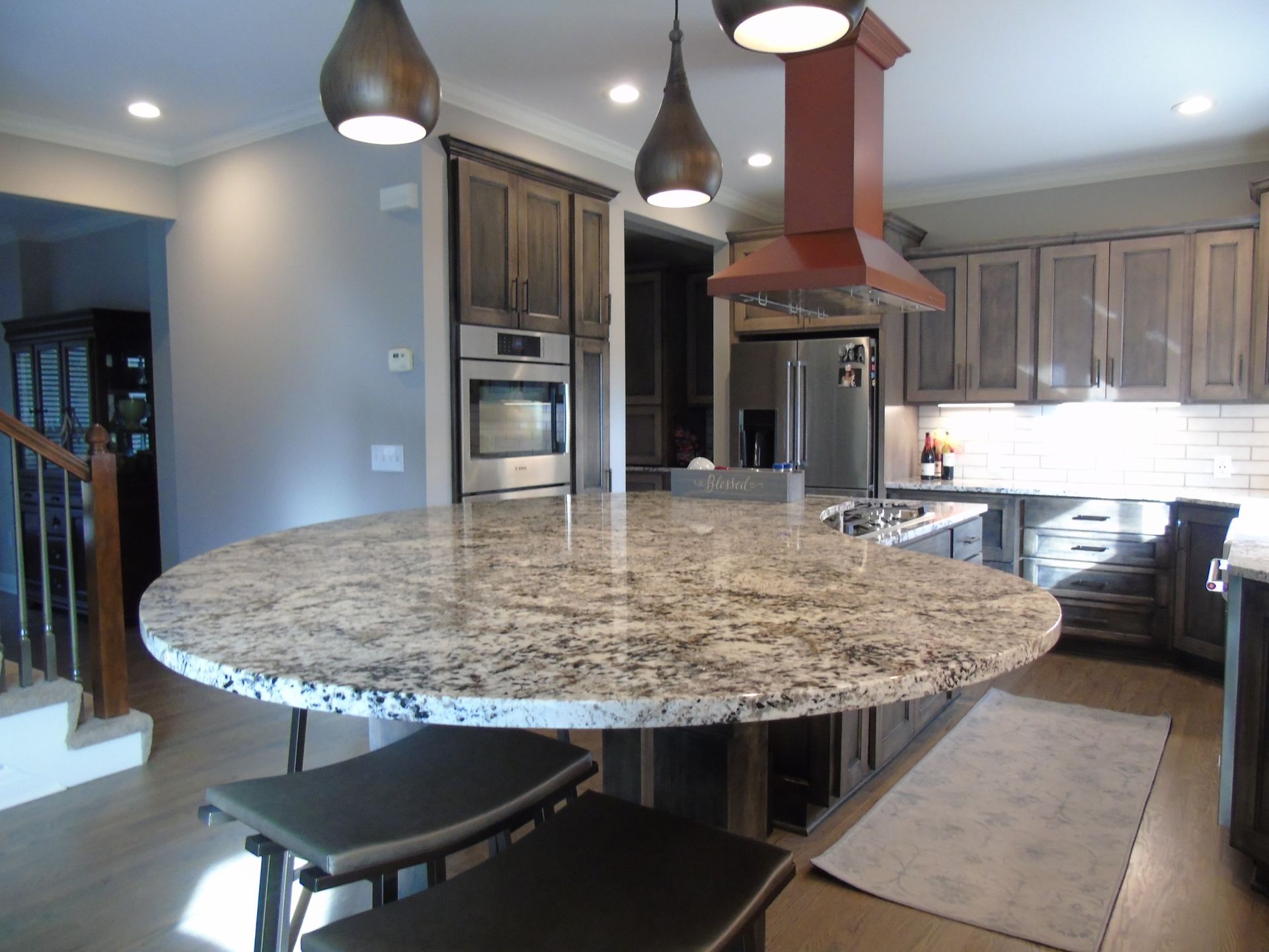 A kitchen with granite countertops and stainless steel appliances.