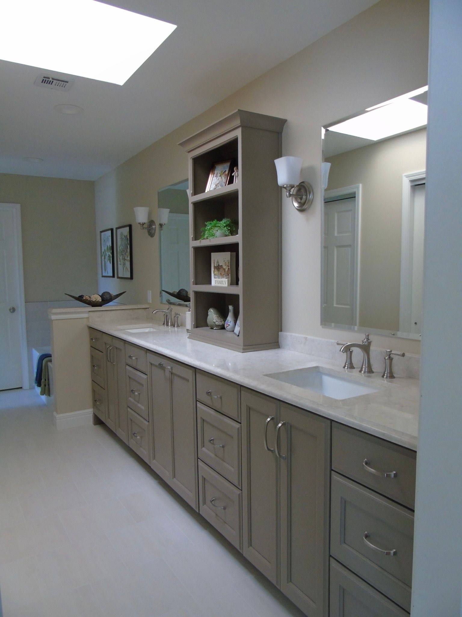 A bathroom with two sinks and a large mirror.