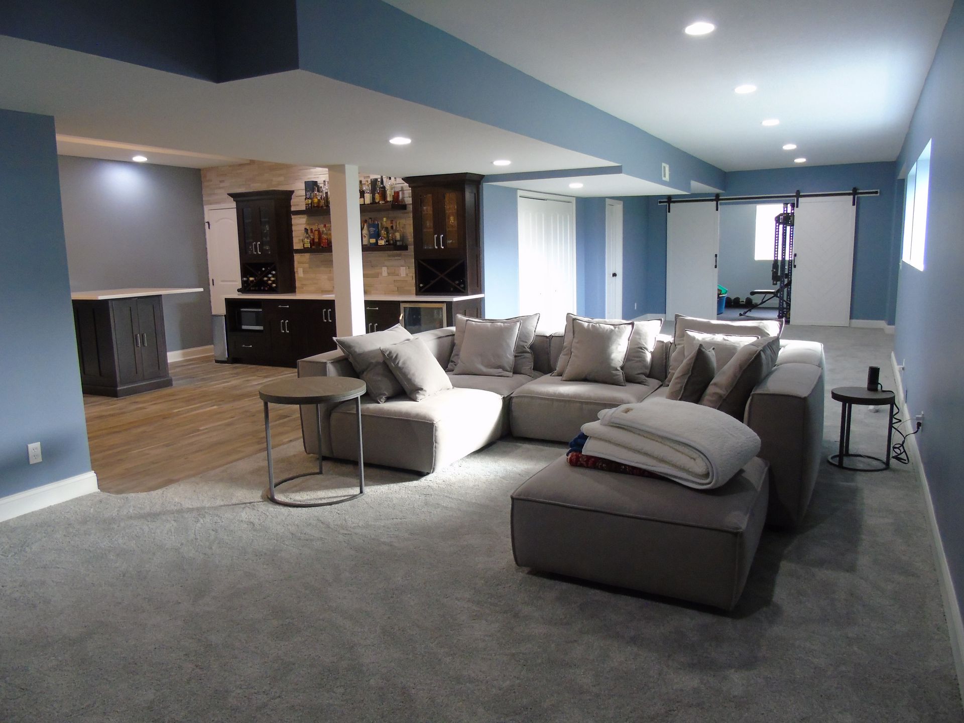 A living room with a sectional couch and a table