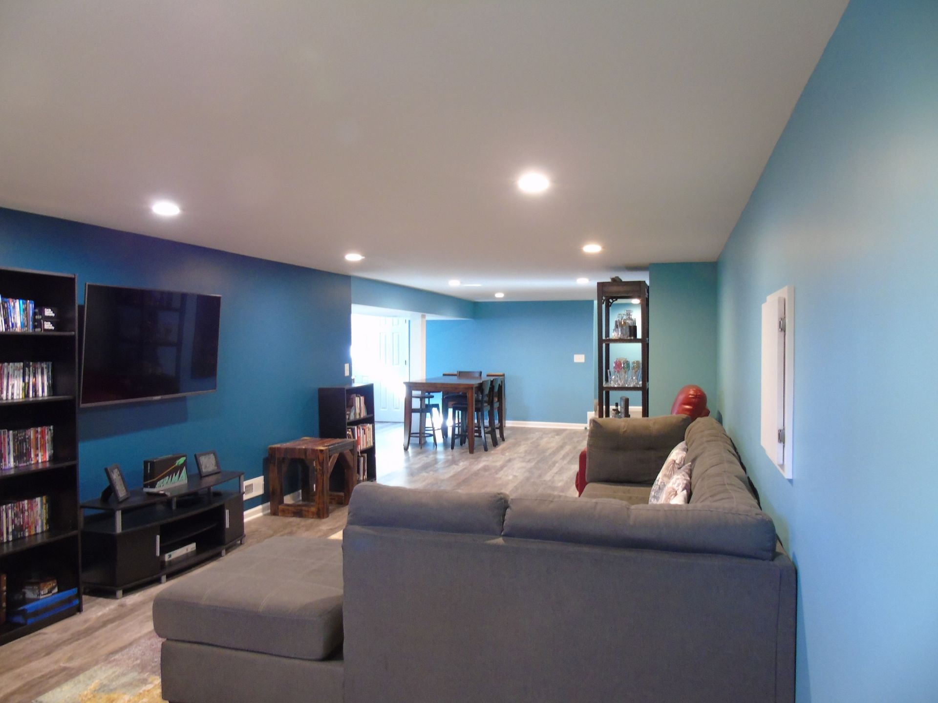 A living room with blue walls and a couch