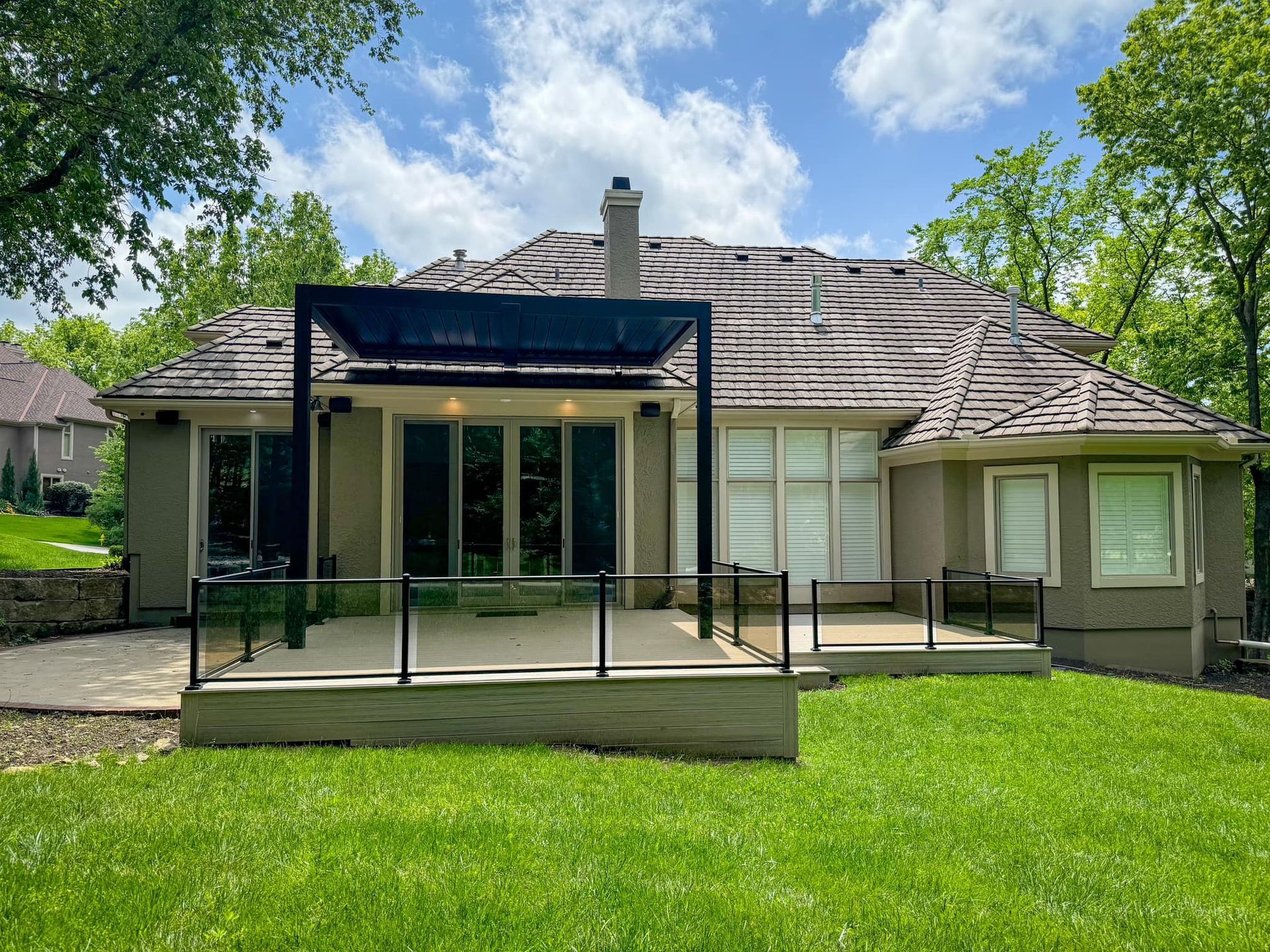 The back of a house with a patio and a pergola.