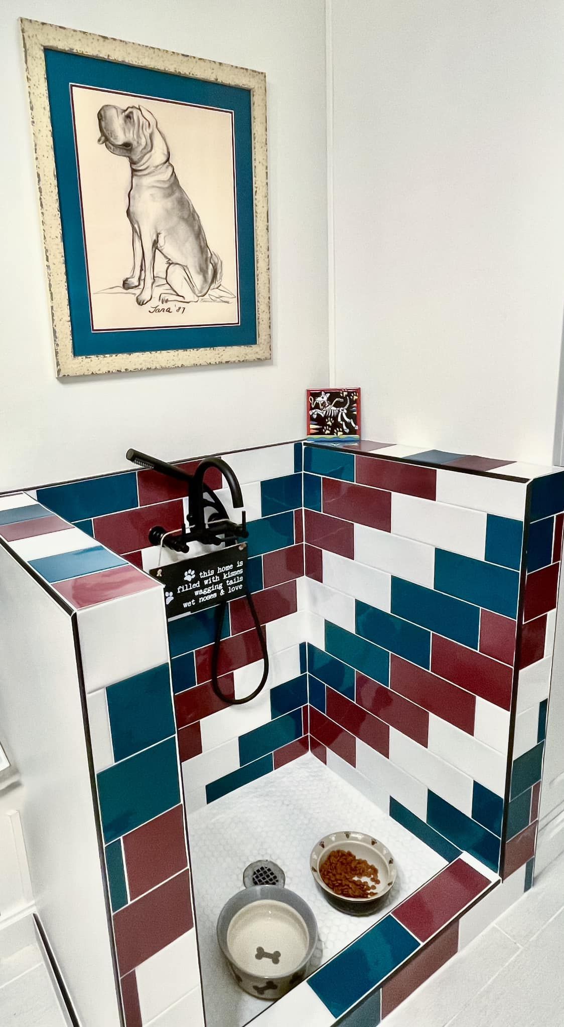 A dog bathtub with a picture of a dog on the wall above it