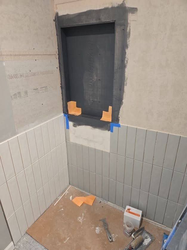 Bathroom tile installation in progress