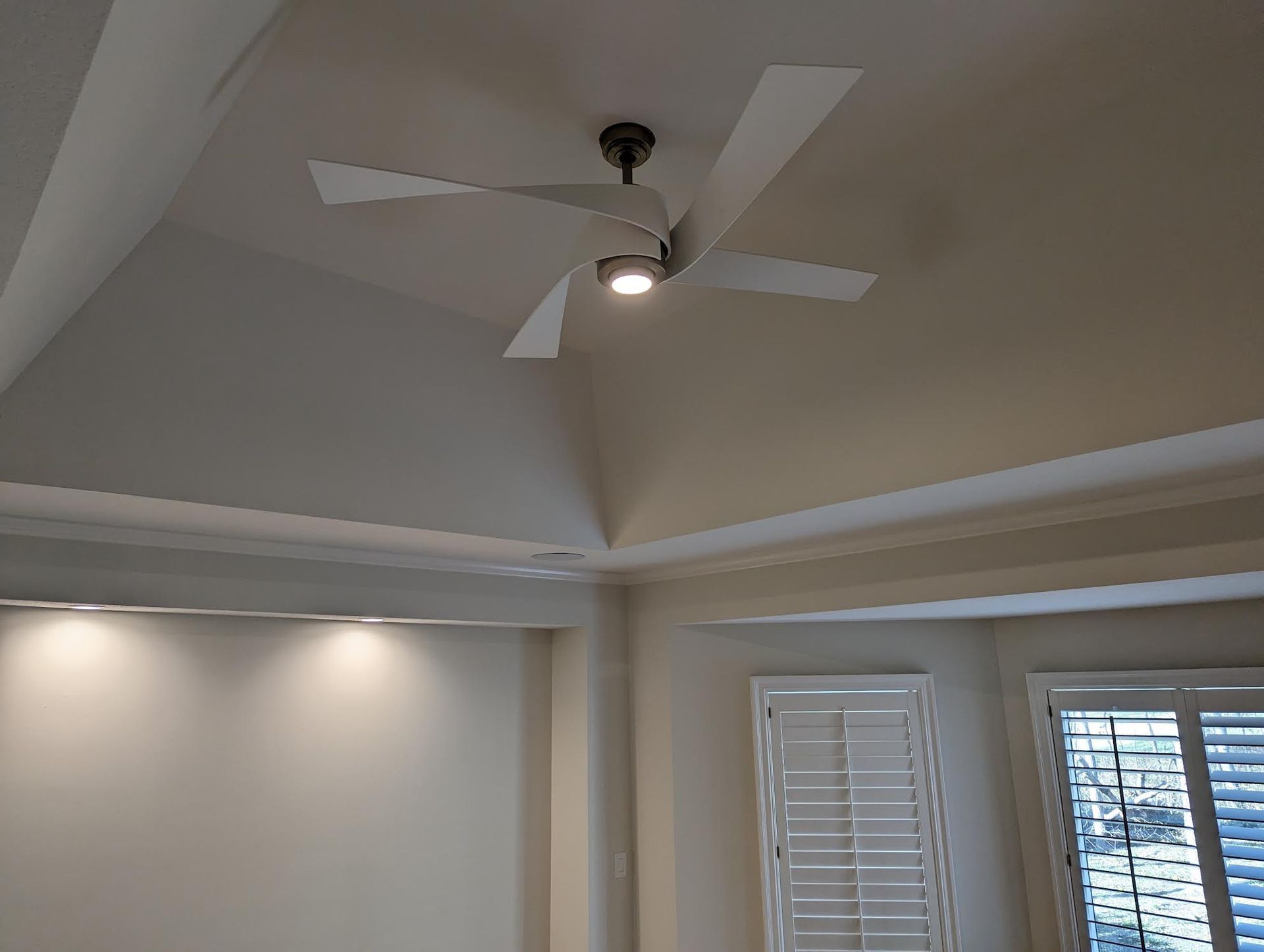Ceiling fan with light in a room with a vaulted ceiling