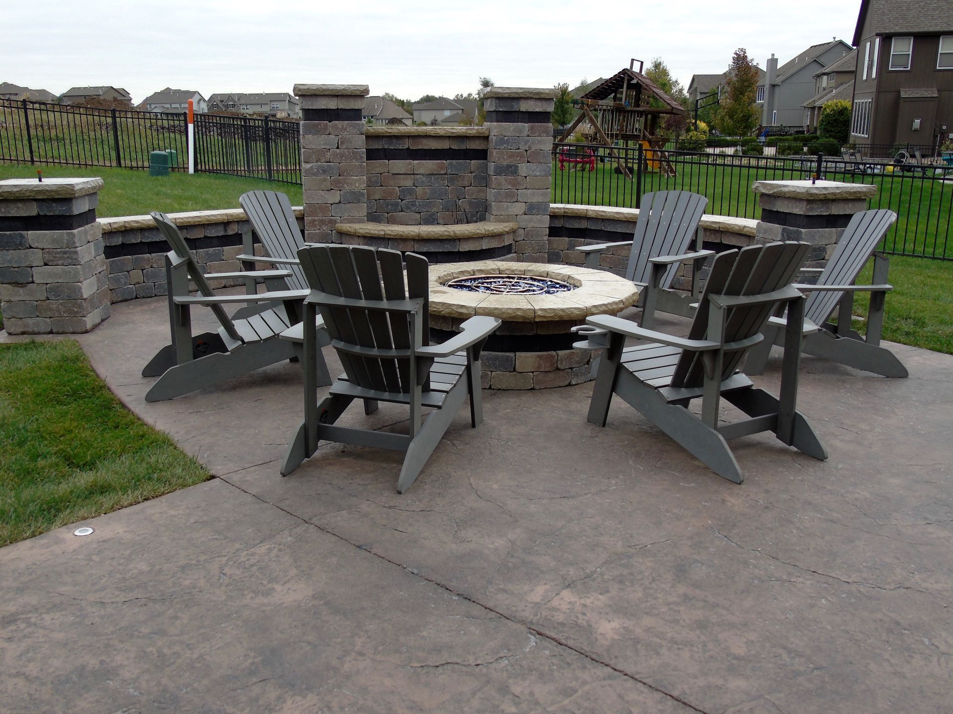 Fire pit with chairs on a stamped concrete patio