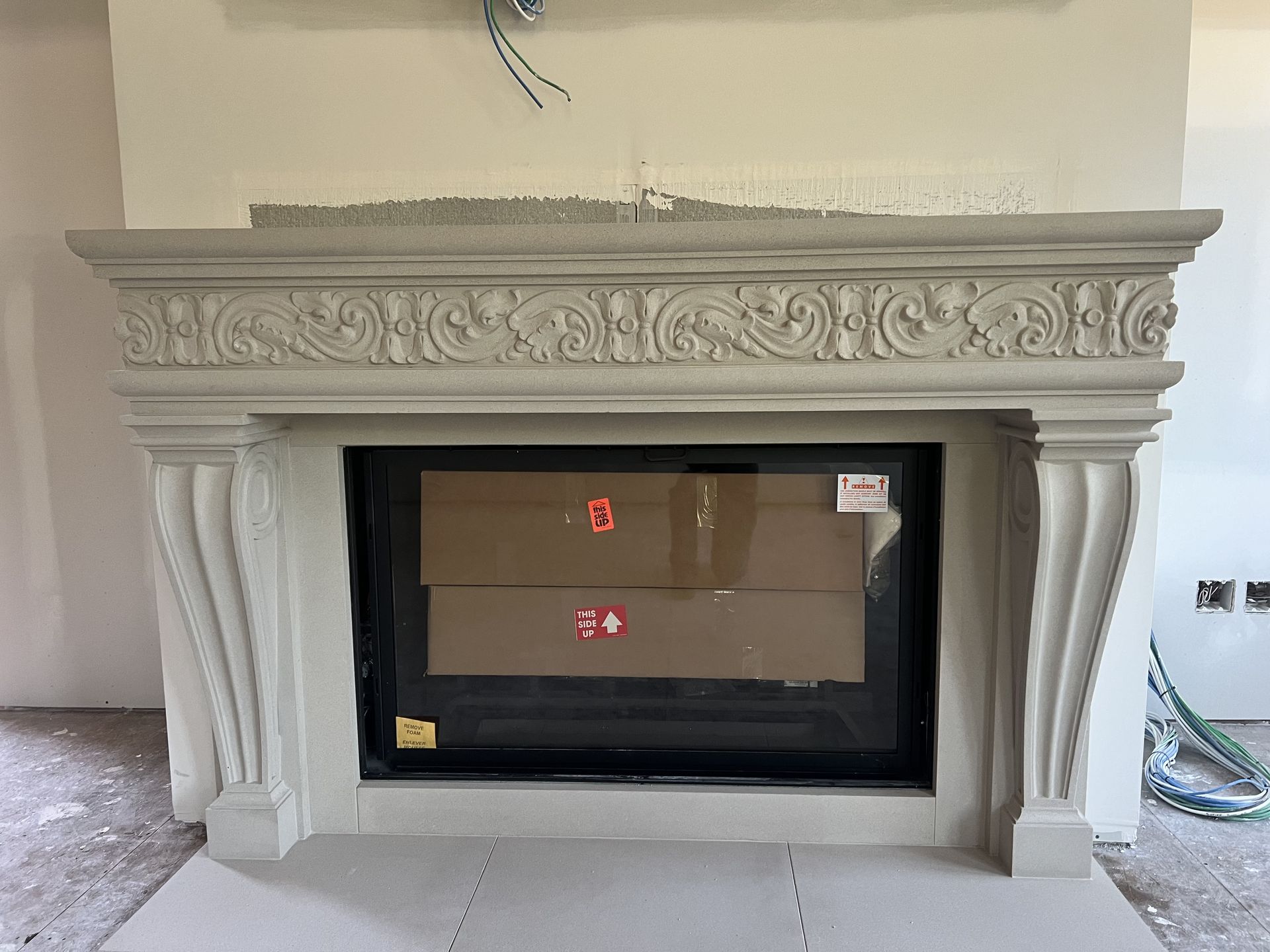 A fireplace with a cardboard box in the middle of it.