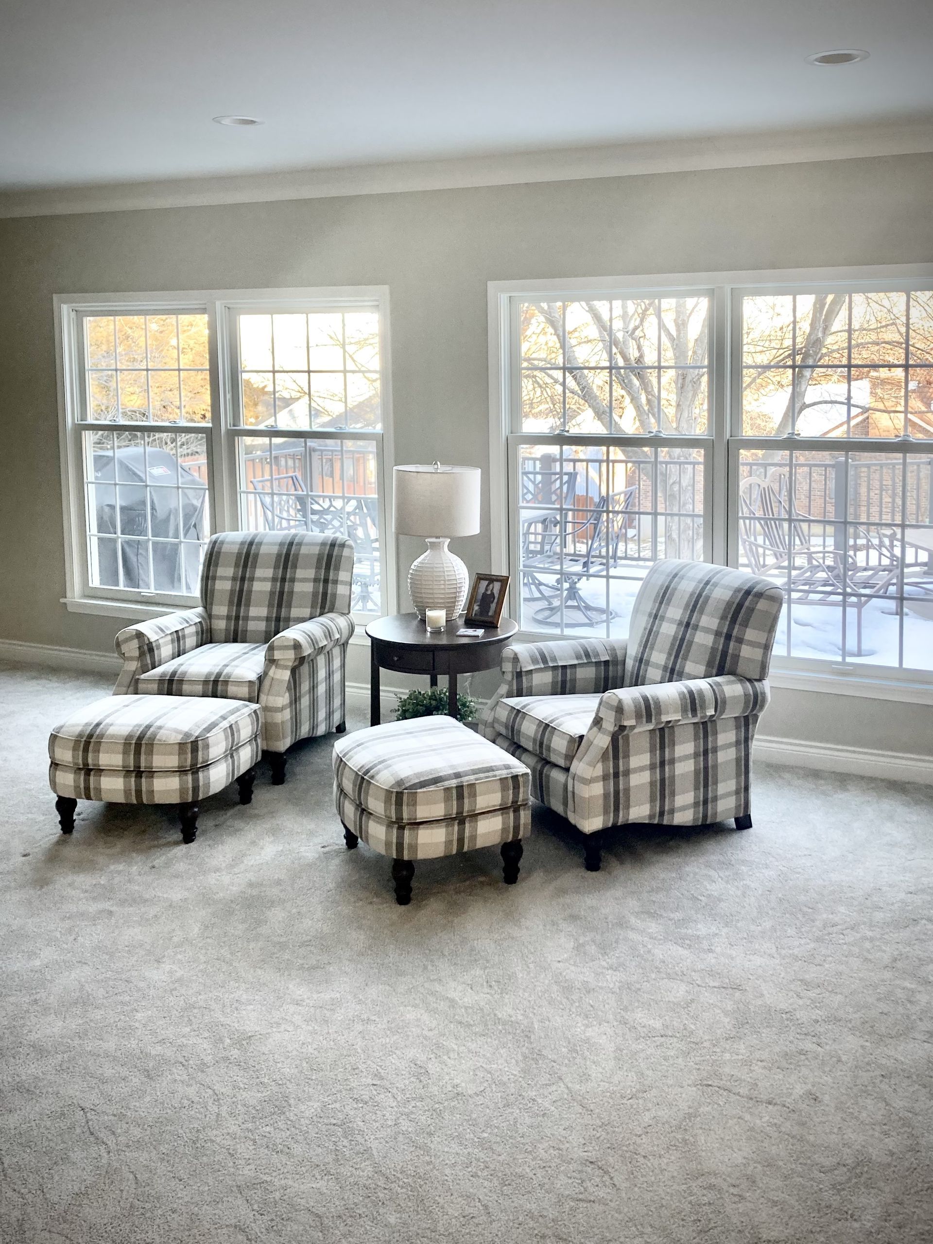 There are two chairs and an ottoman in the living room.